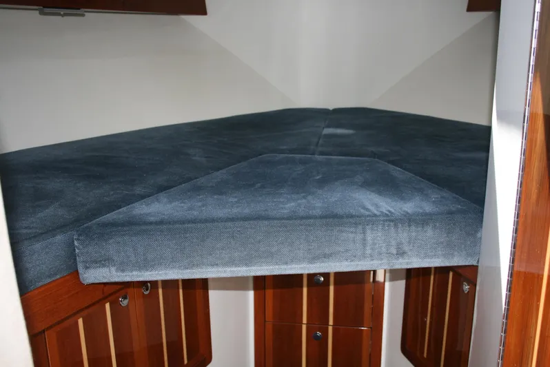 Gypsy Spirit Yacht Photos Pics Interior cabin of 2011 Ocean Sport Roamer 30', featuring a cozy V-berth with blue upholstery.