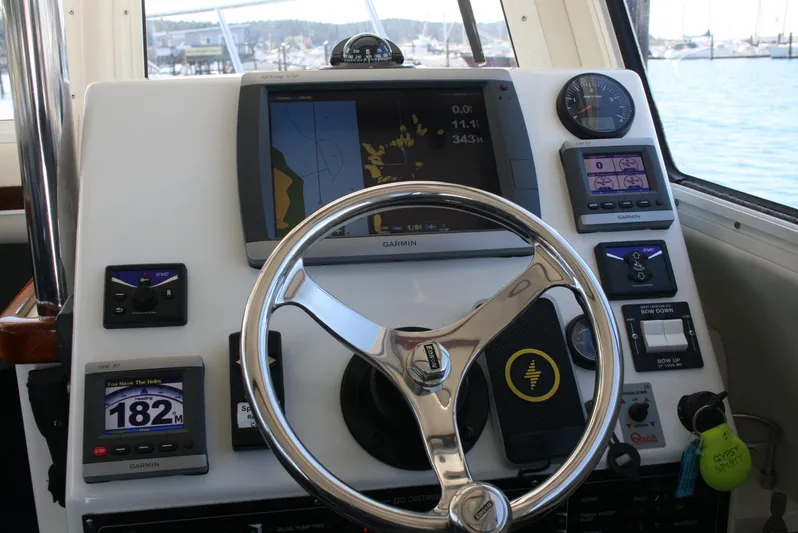 Gypsy Spirit Yacht Photos Pics 2011 Ocean Sport Roamer 30' helm with navigation instruments and steering wheel.