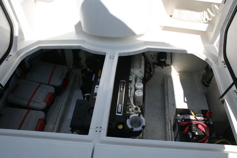 Gypsy Spirit Yacht Photos Pics Engine compartment of a 2011 Ocean Sport Roamer 30' boat, showcasing batteries and engine components.