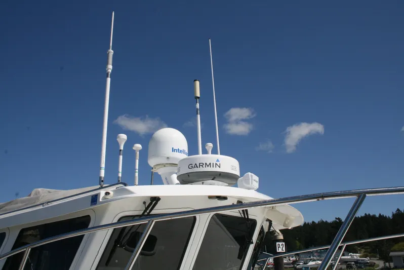 Gypsy Spirit Yacht Photos Pics Ocean Sport Roamer 30' 2011 boat with Garmin and Intellian equipment under clear blue sky.
