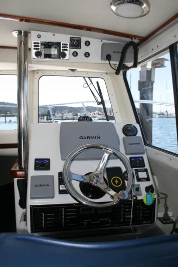 Gypsy Spirit Yacht Photos Pics Cockpit of 2011 Ocean Sport Roamer 30' with Garmin navigation system and steering wheel.