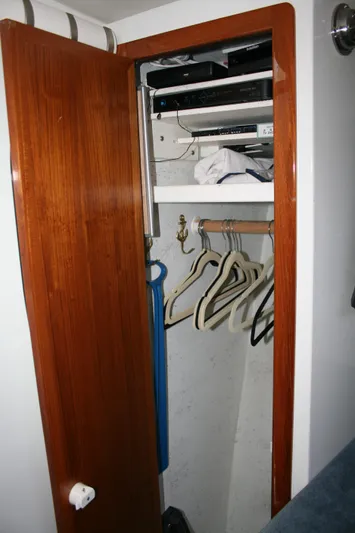 Gypsy Spirit Yacht Photos Pics Wooden closet interior on 2011 Ocean Sport Roamer 30' boat with hangers and shelves.
