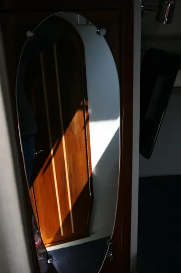 Gypsy Spirit Yacht Photos Pics Mirror reflection inside 2011 Ocean Sport Roamer 30' boat cabin, highlighting wooden interior.