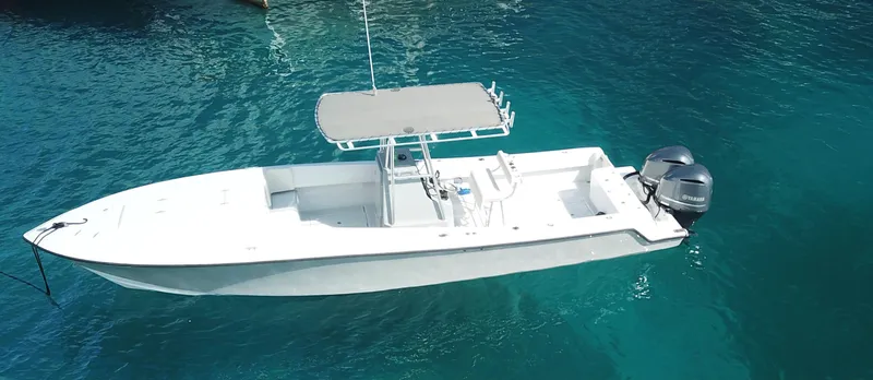 Swell Chaser Yacht Photos Pics 2005 Contender 31 boat on clear water.