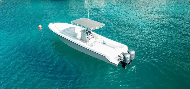 Swell Chaser Yacht Photos Pics 2005 Contender 31 boat on clear blue water.