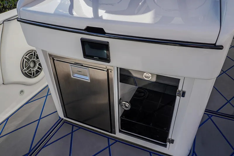  Yacht Photos Pics 2024 Renegade 38 Open boat interior with stainless steel fridge and storage compartment.