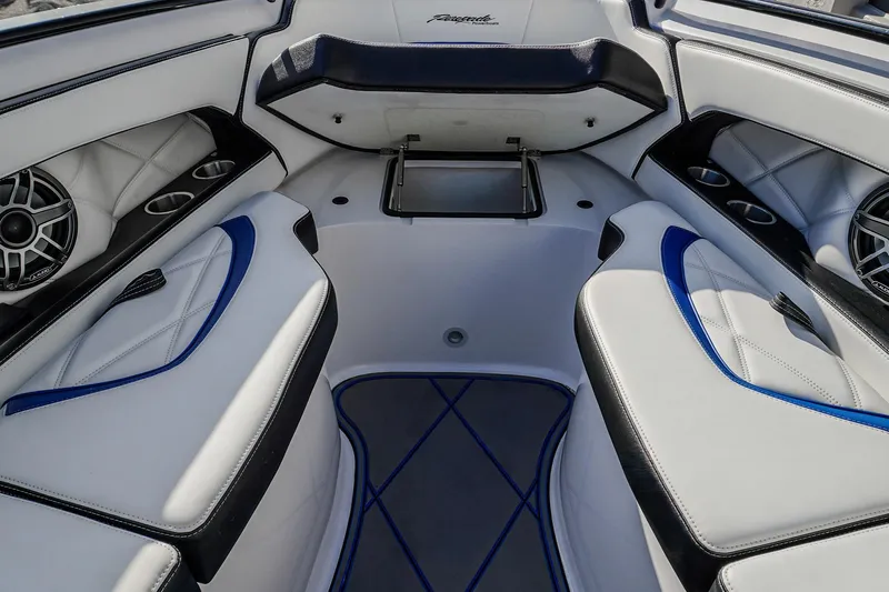  Yacht Photos Pics 2024 Renegade 38 Open boat interior with white and blue seating, cup holders, and speakers.