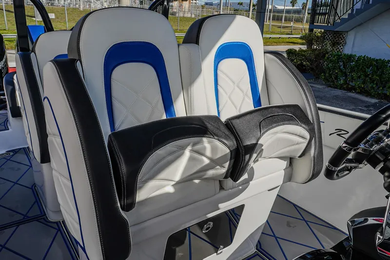  Yacht Photos Pics 2024 Renegade 38 Open boat seats with blue and black accents, showcasing luxury design.