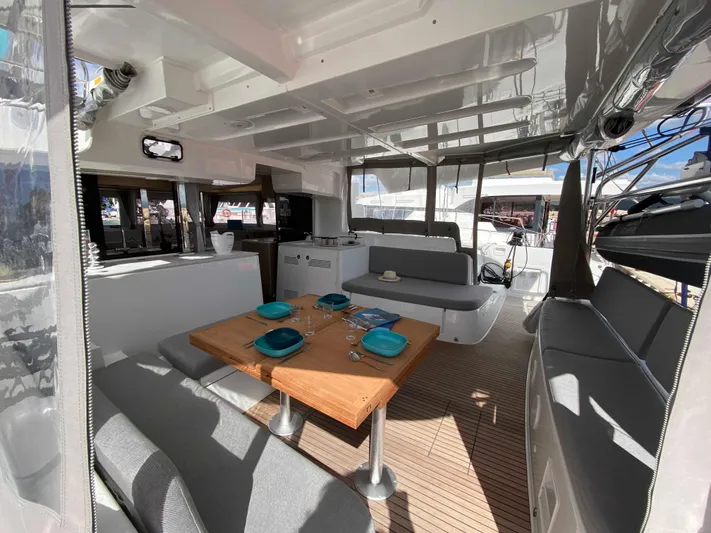  Yacht Photos Pics Spacious interior of 2025 Lagoon 46 catamaran with elegant dining setup.