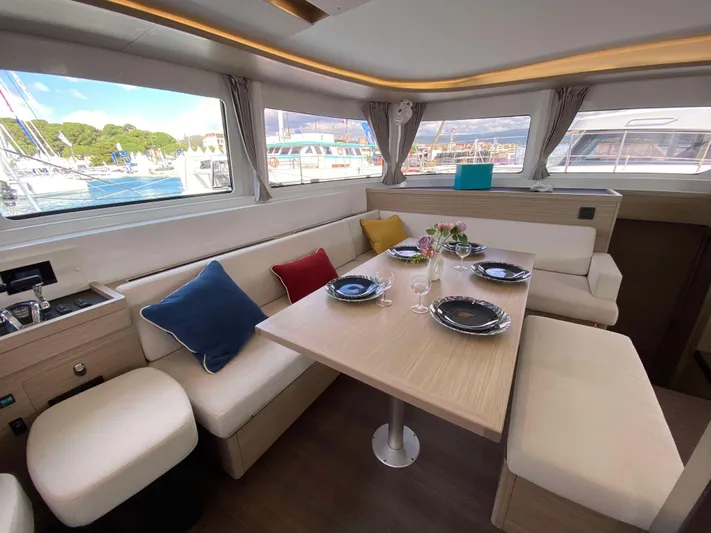  Yacht Photos Pics Luxurious interior of 2025 Lagoon 46 yacht with elegant dining setup.