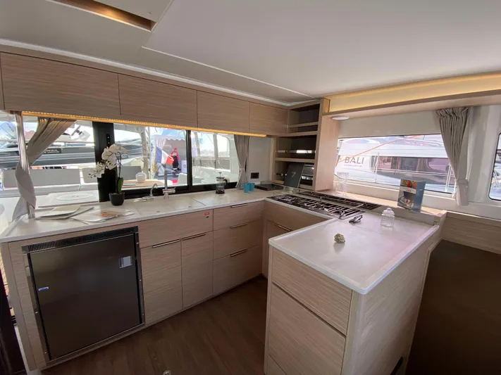  Yacht Photos Pics Modern kitchen interior of 2025 Lagoon 46 yacht with sleek design and ample natural light.