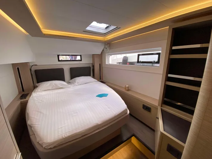  Yacht Photos Pics Luxurious cabin interior of 2025 Lagoon 46 yacht with modern lighting and cozy bed.