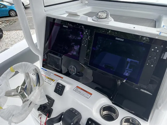  Yacht Photos Pics 2025 NauticStar 292 Legacy boat dashboard with dual Simrad displays and steering wheel.