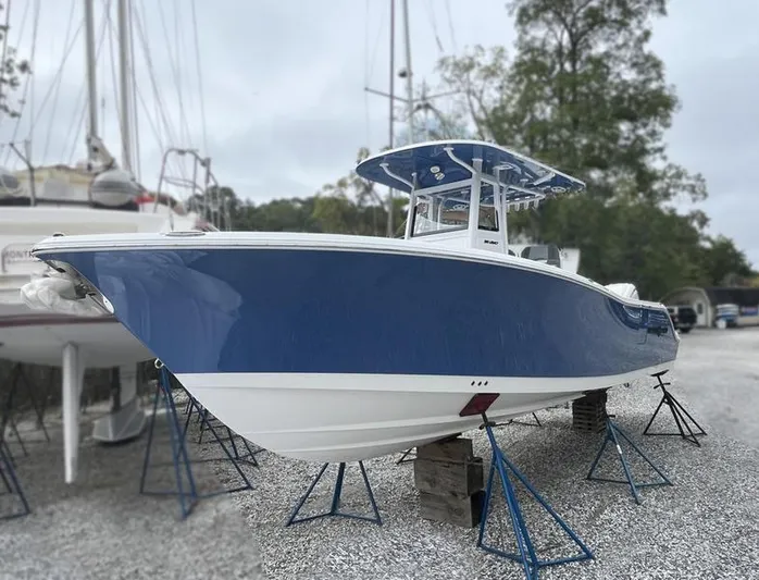  Yacht Photos Pics 2025 NauticStar 292 Legacy boat in dry dock, blue and white hull.