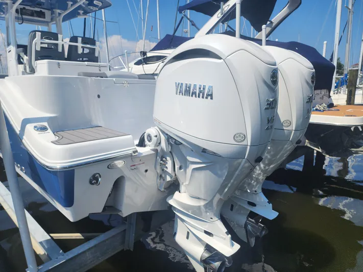  Yacht Photos Pics 2025 NauticStar 292 Legacy boat with dual Yamaha outboard engines at a marina.