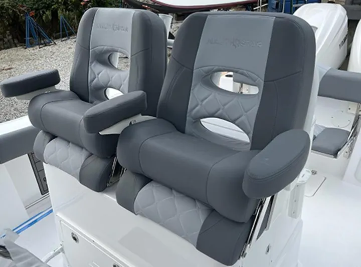  Yacht Photos Pics 2025 NauticStar 292 Legacy boat seats, featuring gray cushioned design with armrests.