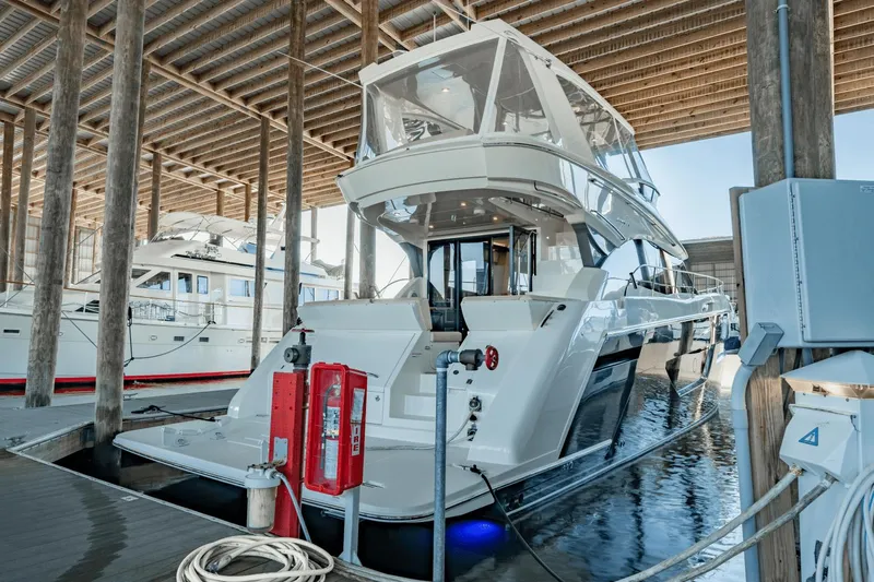 Telesto Yacht Photos Pics 2017 Carver 52 Command Bridge yacht docked in a covered marina.