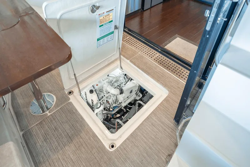 Telesto Yacht Photos Pics Engine compartment of 2017 Carver 52 Command Bridge yacht, open hatch view.