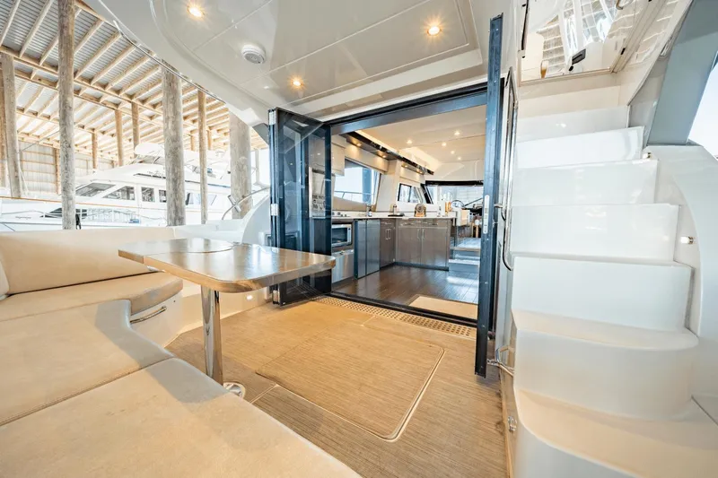 Telesto Yacht Photos Pics Luxurious interior of 2017 Carver 52 Command Bridge yacht with modern kitchen and seating area.