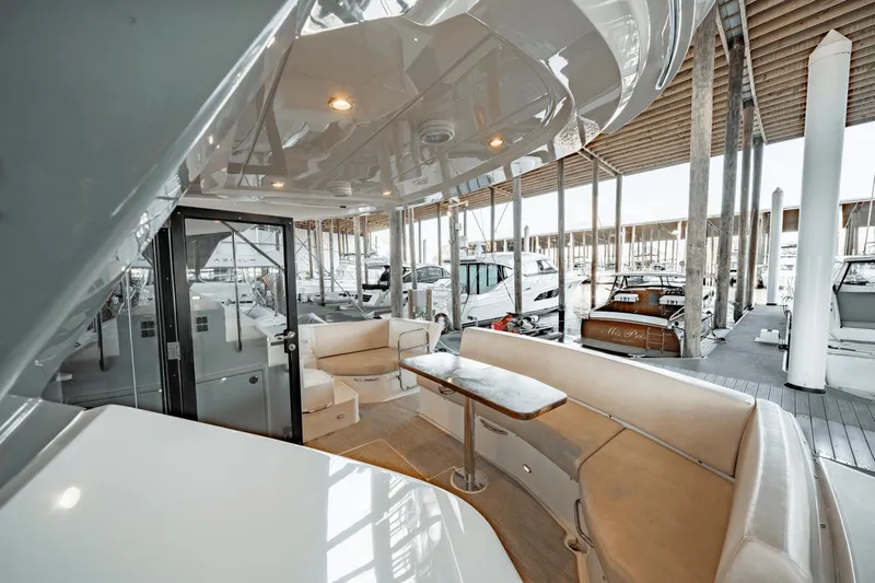 Telesto Yacht Photos Pics 2017 Carver 52 Command Bridge yacht interior with seating and table in marina setting.