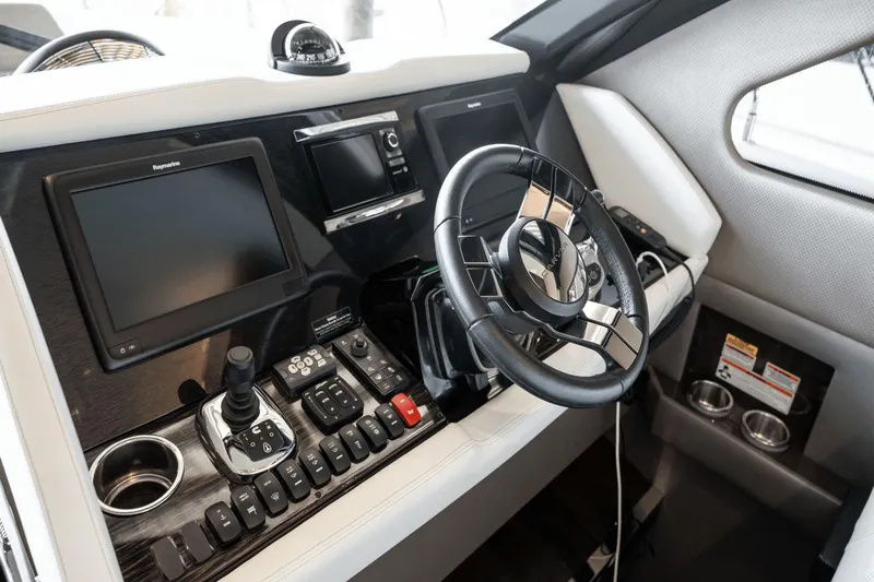 Telesto Yacht Photos Pics Helm of 2017 Carver 52 Command Bridge with modern controls and navigation displays.