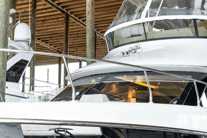 Telesto Yacht Photos Pics 2017 Carver 52 Command Bridge yacht docked under wooden shelter.