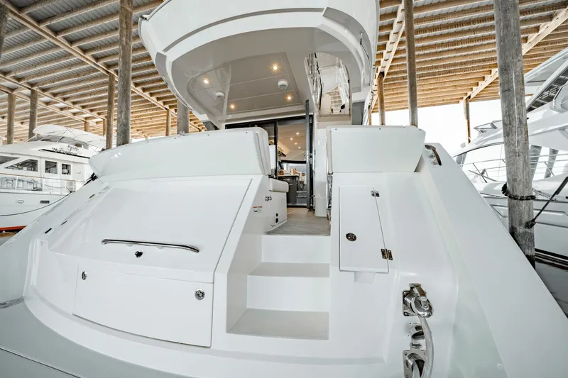 Telesto Yacht Photos Pics 2017 Carver 52 Command Bridge yacht, rear view, docked under a wooden canopy.