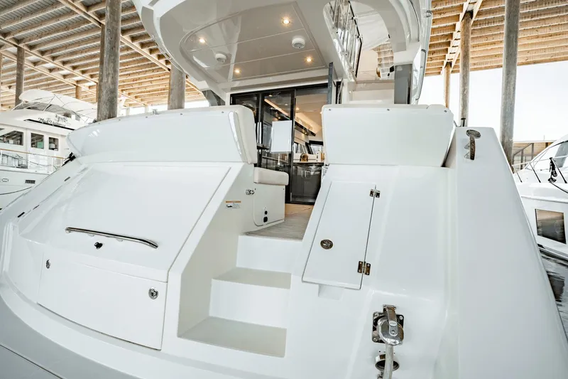 Telesto Yacht Photos Pics 2017 Carver 52 Command Bridge yacht stern view in marina setting.