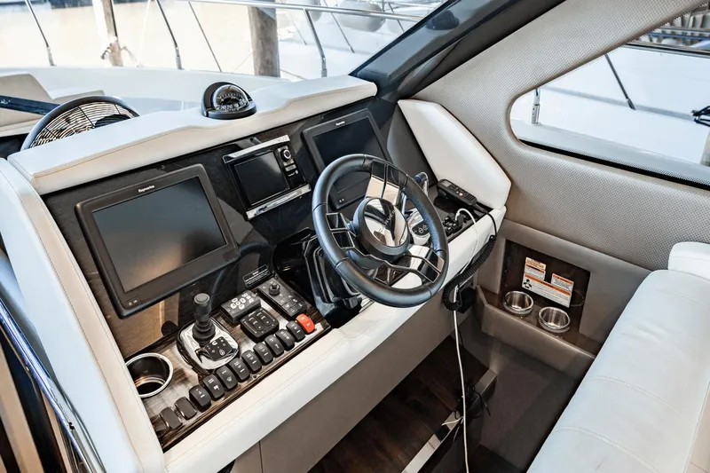 Telesto Yacht Photos Pics Interior helm of 2017 Carver 52 Command Bridge with modern navigation controls.