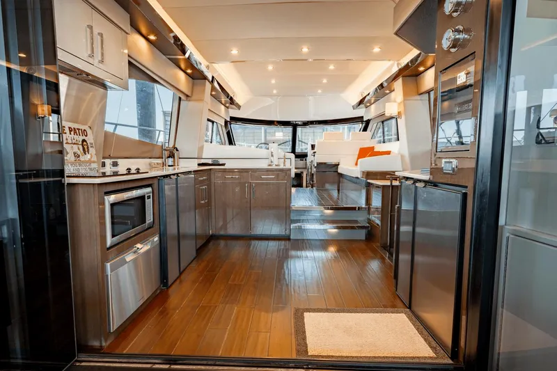 Telesto Yacht Photos Pics Luxurious interior of 2017 Carver 52 Command Bridge yacht with modern kitchen and seating area.