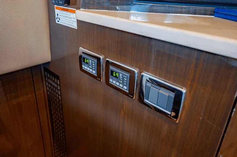 Telesto Yacht Photos Pics Control panel on 2017 Carver 52 Command Bridge yacht interior, featuring digital displays and switches.