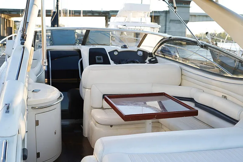  Yacht Photos Pics Sunseeker Superhawk 48 Mk II 2000 yacht interior with white seating and wooden table.