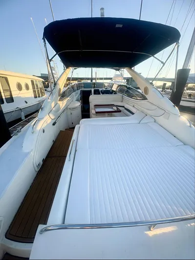 Yacht Photos Pics Sunseeker Superhawk 48 Mk II 2000 yacht with spacious deck and seating area, docked at marina.