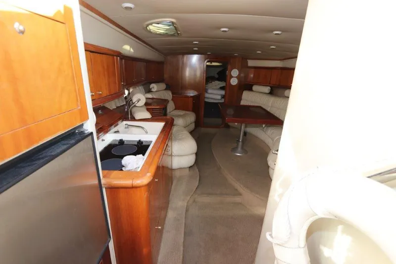  Yacht Photos Pics Interior of 2000 Sunseeker Superhawk 48 Mk II yacht with kitchen and seating area.