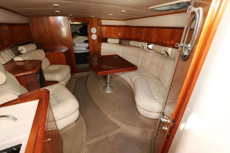  Yacht Photos Pics Luxurious interior of 2000 Sunseeker Superhawk 48 Mk II yacht with plush seating and wooden accents.