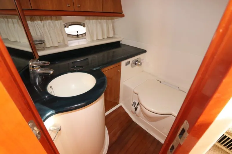  Yacht Photos Pics Bathroom interior of 2000 Sunseeker Superhawk 48 Mk II yacht, featuring sink and toilet.