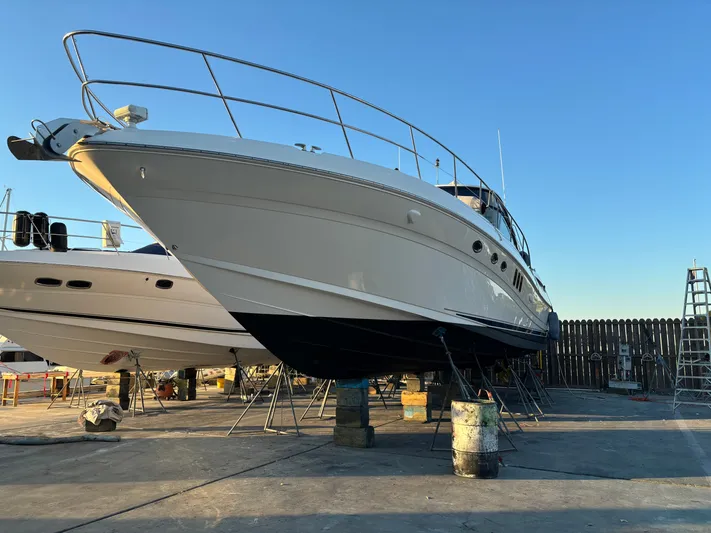52 Sea Ray Sundancer Yacht Photos Pics 2009 Sea Ray 52 Sundancer yacht on dry dock under clear blue sky.