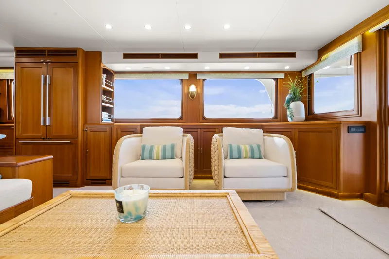  Yacht Photos Pics Luxurious interior of 2023 Fleming 65 yacht with elegant seating and wooden finishes.