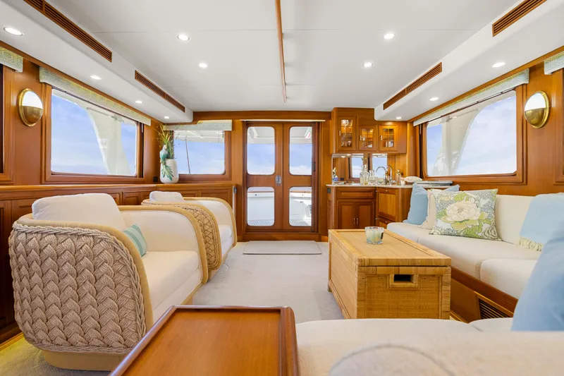  Yacht Photos Pics Luxurious interior of 2023 Fleming 65 yacht with elegant seating and wooden accents.