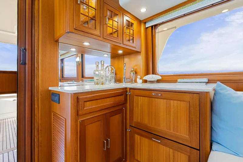  Yacht Photos Pics Luxurious wooden interior of 2023 Fleming 65 yacht with elegant cabinetry and ocean view.