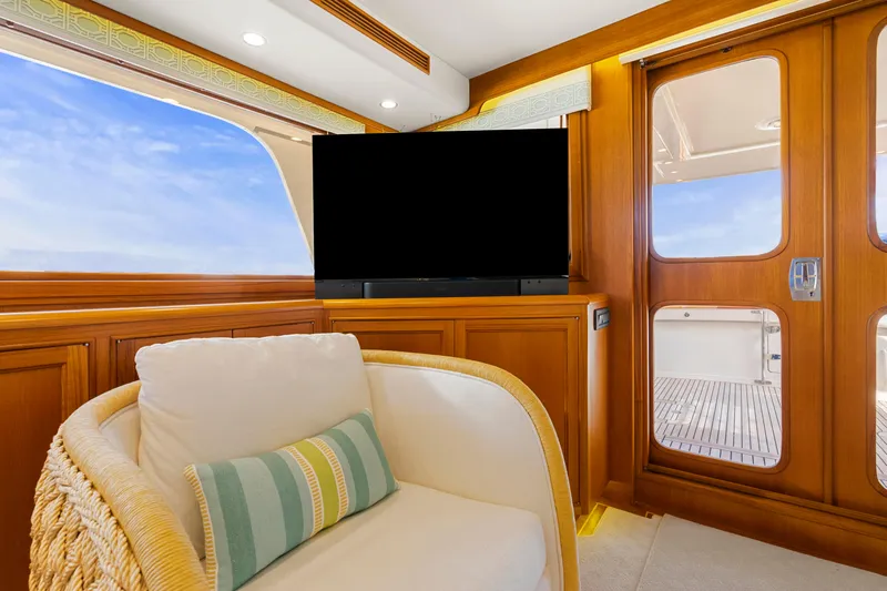  Yacht Photos Pics Luxurious interior of 2023 Fleming 65 yacht with plush seating and large TV.