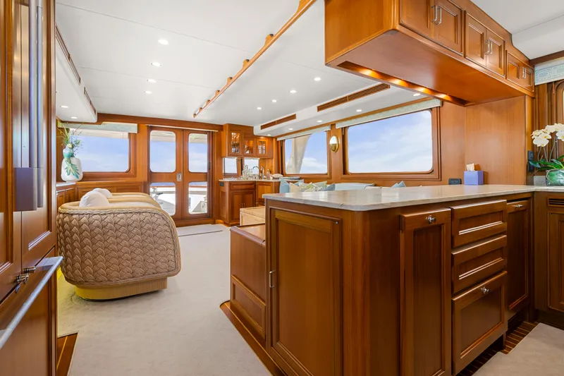  Yacht Photos Pics Luxurious interior of 2023 Fleming 65 yacht with elegant wood finishes and modern amenities.
