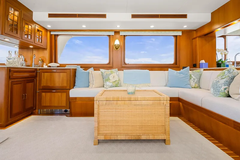  Yacht Photos Pics Luxurious interior of 2023 Fleming 65 yacht with elegant wood finish and plush seating.