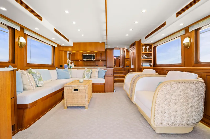  Yacht Photos Pics Luxurious interior of 2023 Fleming 65 yacht with elegant seating and wooden finishes.