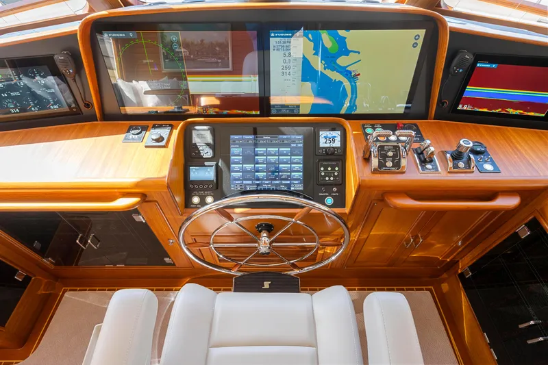  Yacht Photos Pics 2023 Fleming 65 yacht helm with advanced navigation displays and controls.