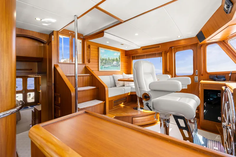  Yacht Photos Pics Luxurious interior of 2023 Fleming 65 yacht with elegant wood finishes and plush seating.