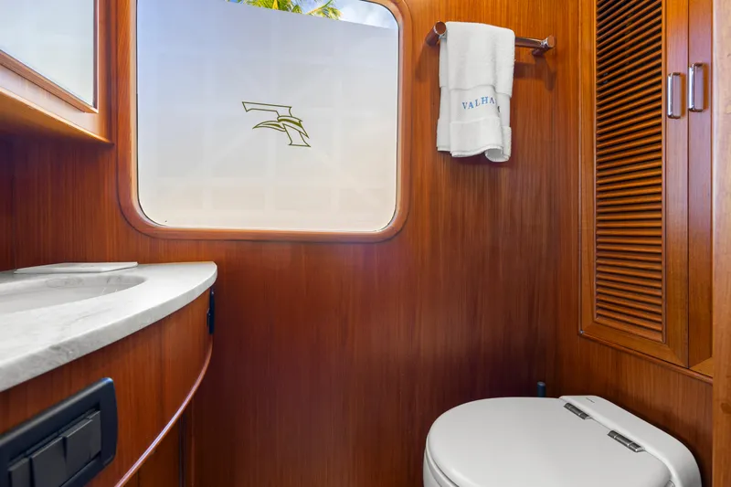  Yacht Photos Pics Luxurious 2023 Fleming 65 yacht bathroom with wood paneling and modern fixtures.