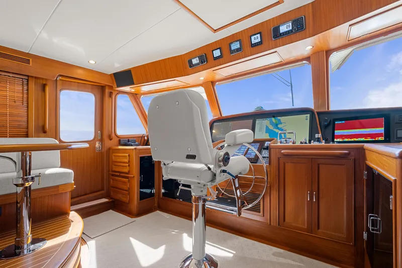  Yacht Photos Pics Luxurious 2023 Fleming 65 yacht interior with modern navigation equipment and elegant wood finishes.