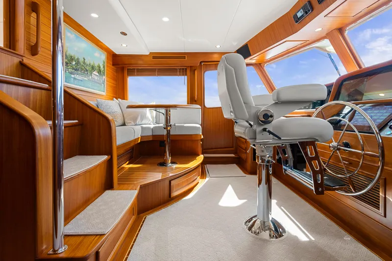  Yacht Photos Pics Luxurious interior of 2023 Fleming 65 yacht with plush seating and modern helm.