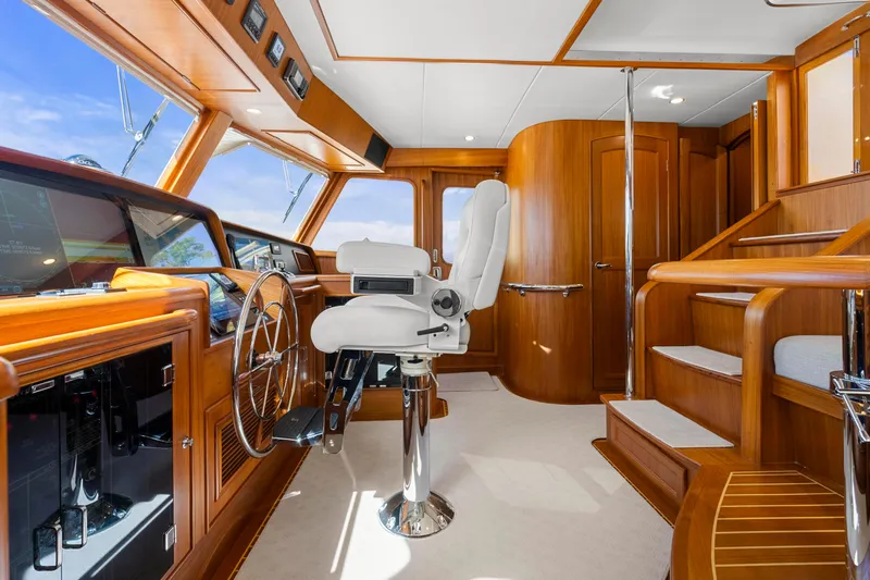  Yacht Photos Pics Luxurious 2023 Fleming 65 yacht interior with polished wood and modern helm station.
